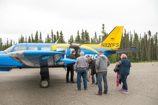 "The Captain" of our flight helps his passengers retrieve "baggage" from the cubby in the wing