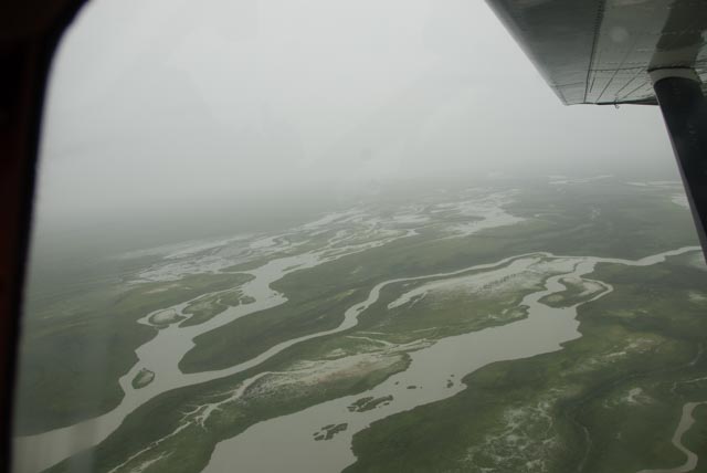 The water drains to the Cook Inlet across miles of wetlands laced with braided streams.